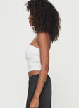 Tube top Strapless style, elasticated bust, shirred material, invisible zip fastening Non-stretch material, fully lined  