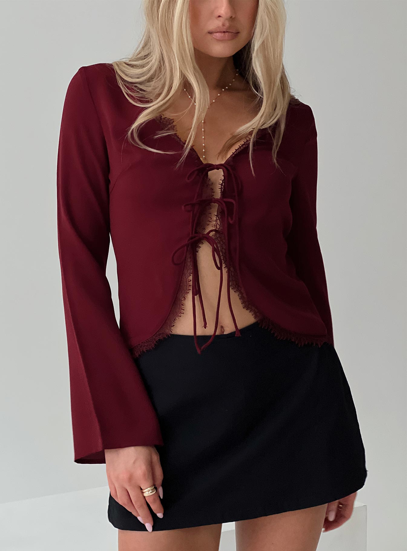front view of model wearing Princess Polly Hagner Long Sleeve Top Burgundy Full Sleeves V-Neck 