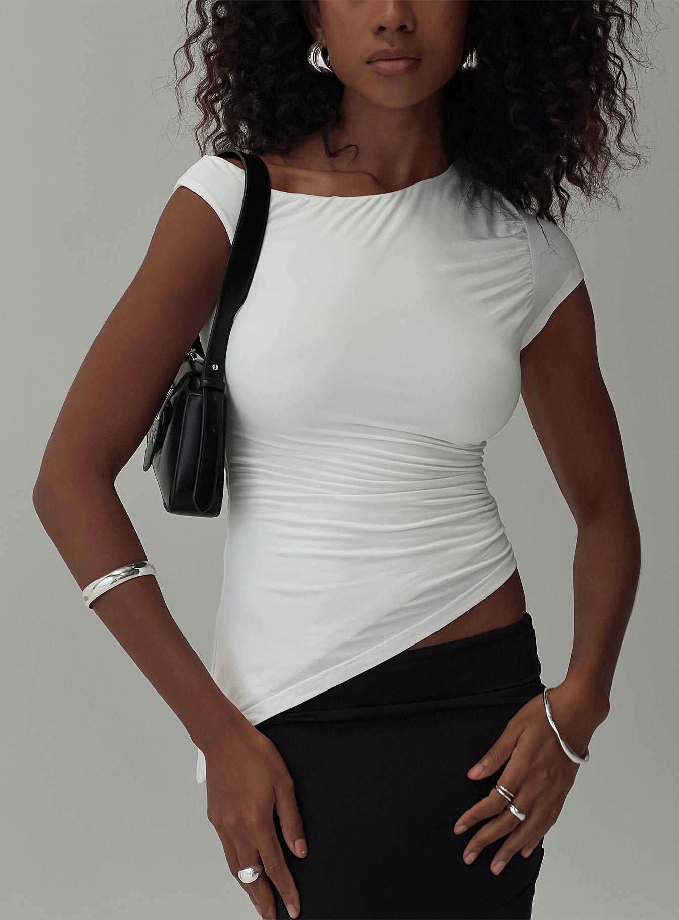 front view of model wearing Princess Polly Evienne Top White Short Sleeves Asymmetric Neckline 
