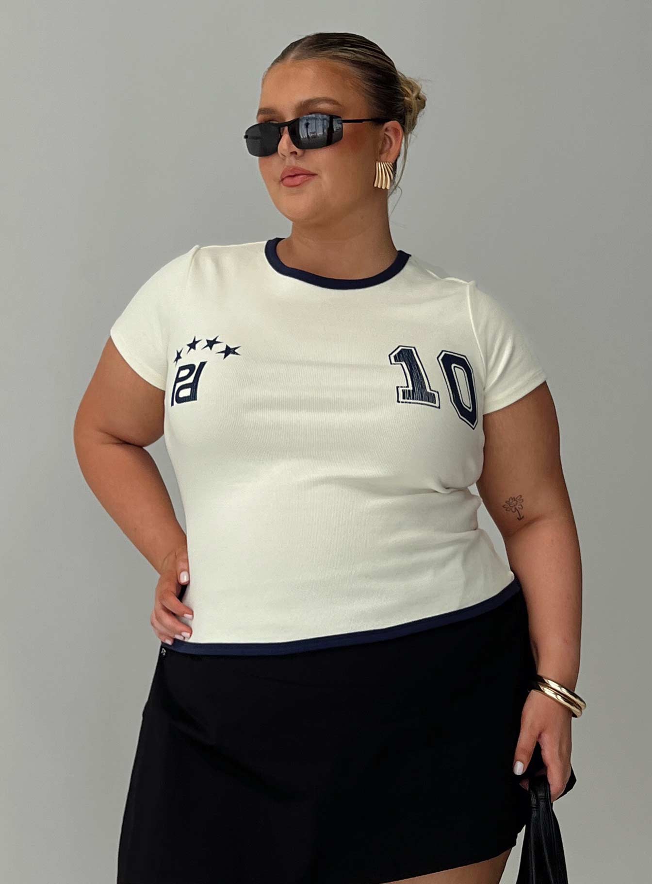 front view of model wearing Princess Polly Track Record Graphic Top Cream Curve Short Sleeves Crew Neck 