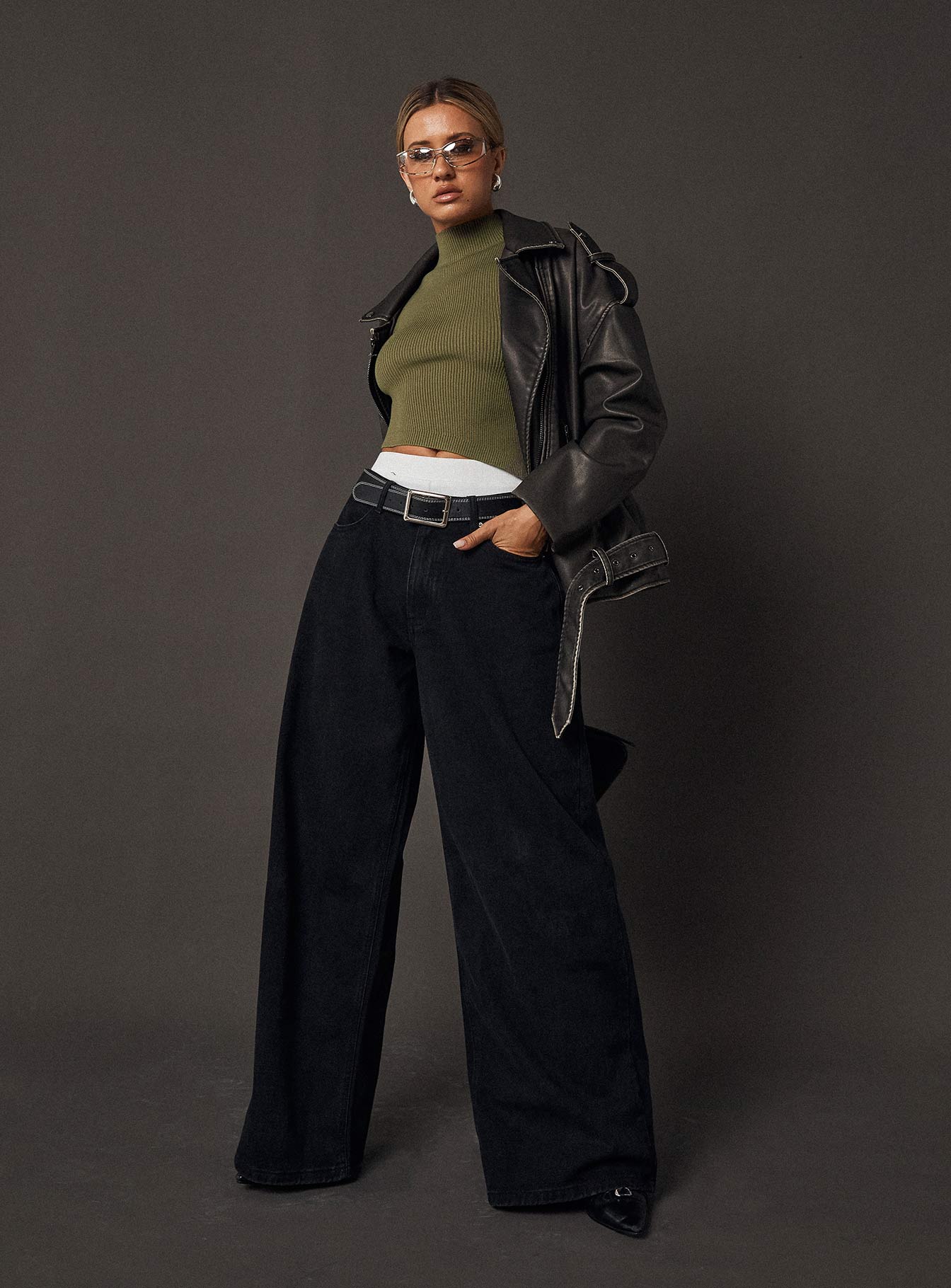 side view of model wearing Princess Polly Naylor Wide Leg Jeans Washed Black Denim Petite High Waisted 