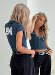 Top Graphic on back, classic collar, deep V-neckline, cap sleeves, faux twin chest pockets Double zipper fastening at front 