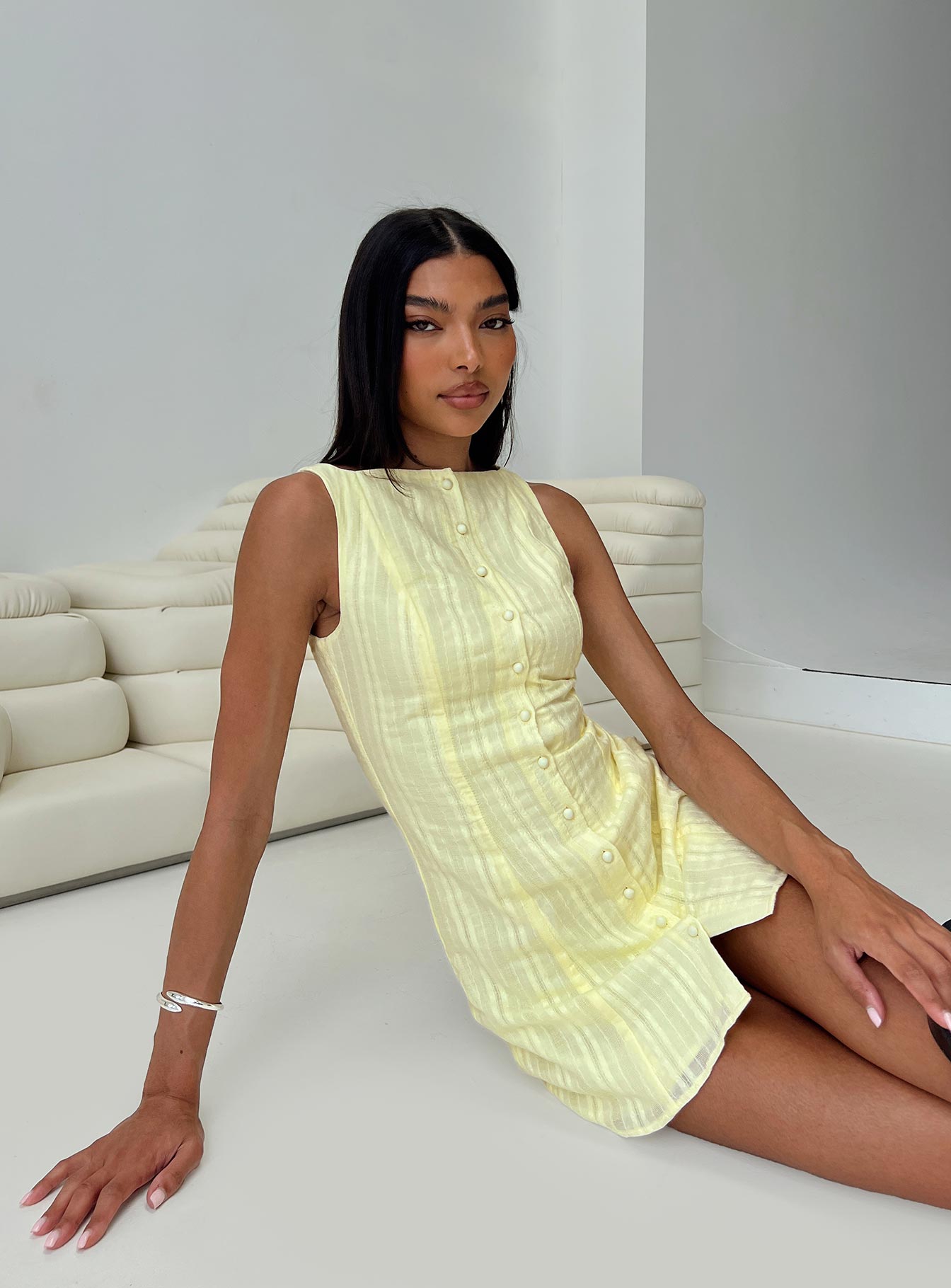 side view of model wearing Princess Polly Mimsie Embroidered Mini Dress Lemon Boat Neck 