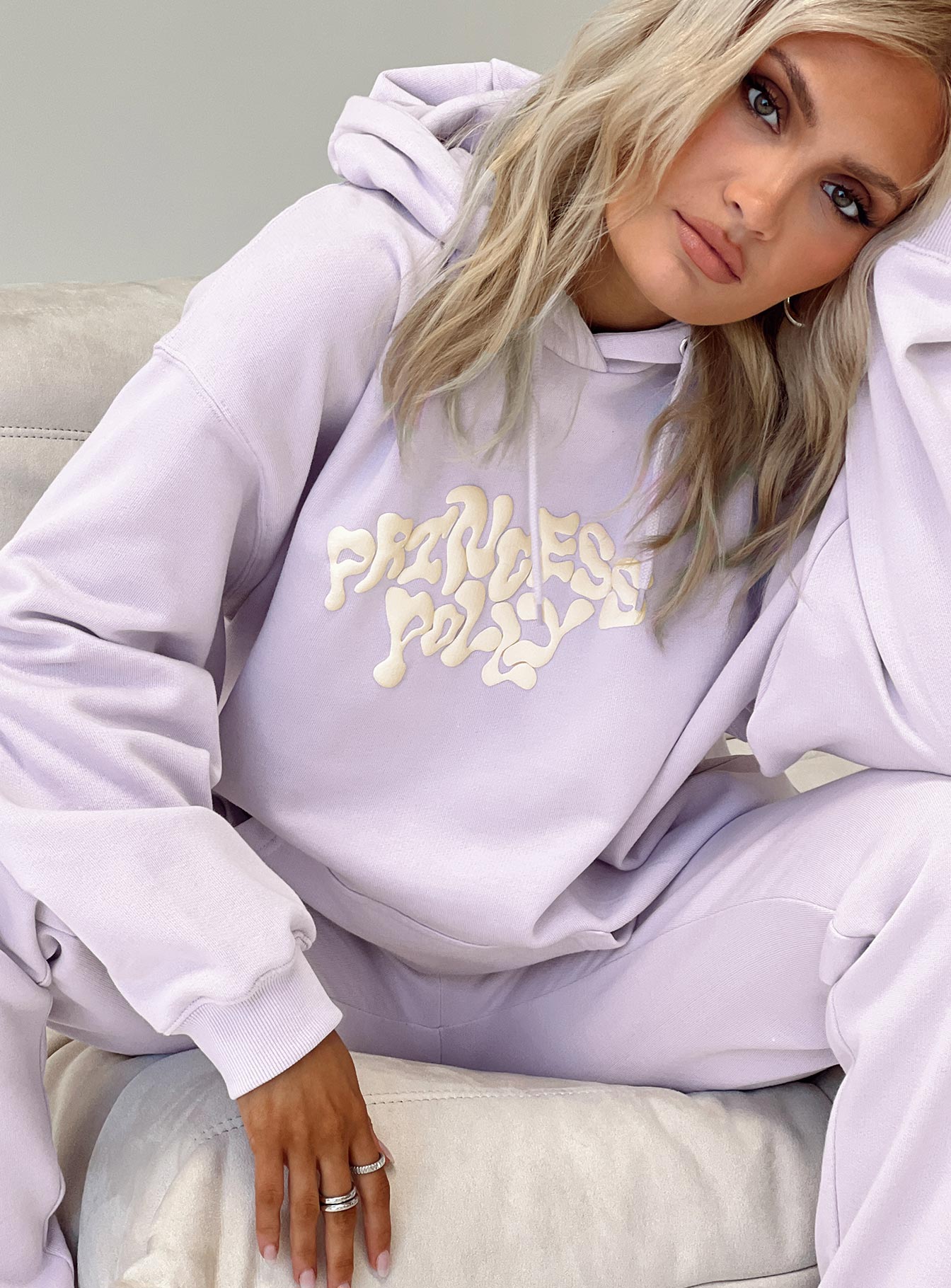 side view of model wearing Princess Polly Princess Polly Hooded Sweatshirt Squiggle Text Dusty Mauve / Eggshell regular 