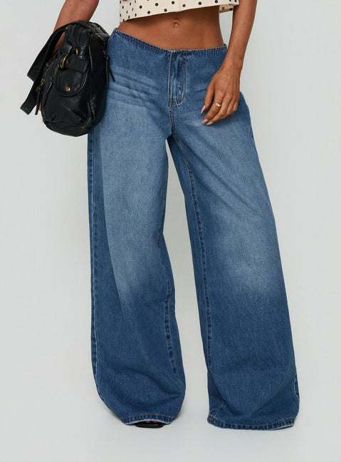 Showcasing the Roamer No Waist Low Rise Super Baggy Vintage Mid Blue womens jeans with low-rise waist front view of model wearing Princess Polly