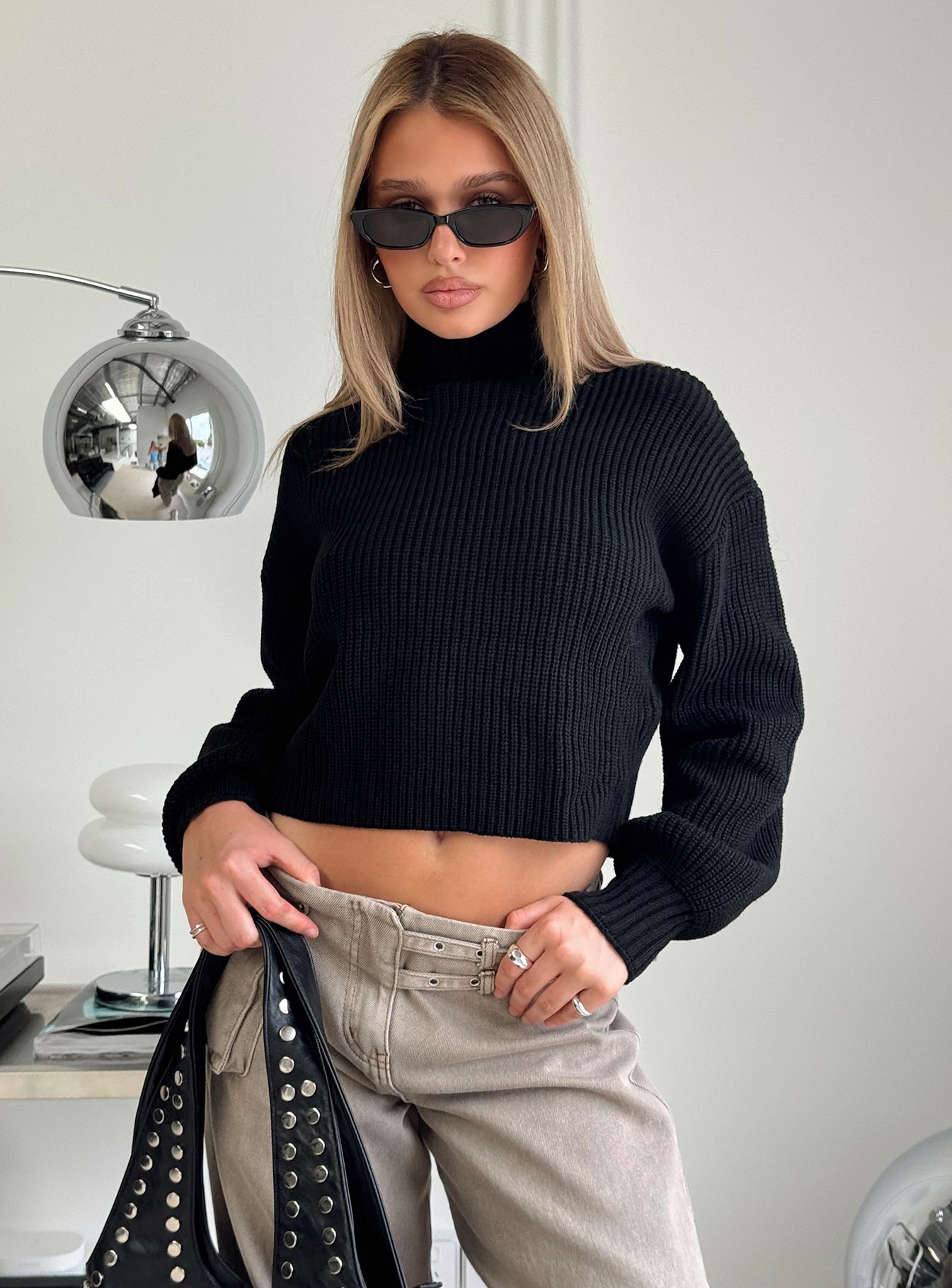 side view of model wearing Princess Polly Sayge Mock Neck Knit Sweater Black cropped 