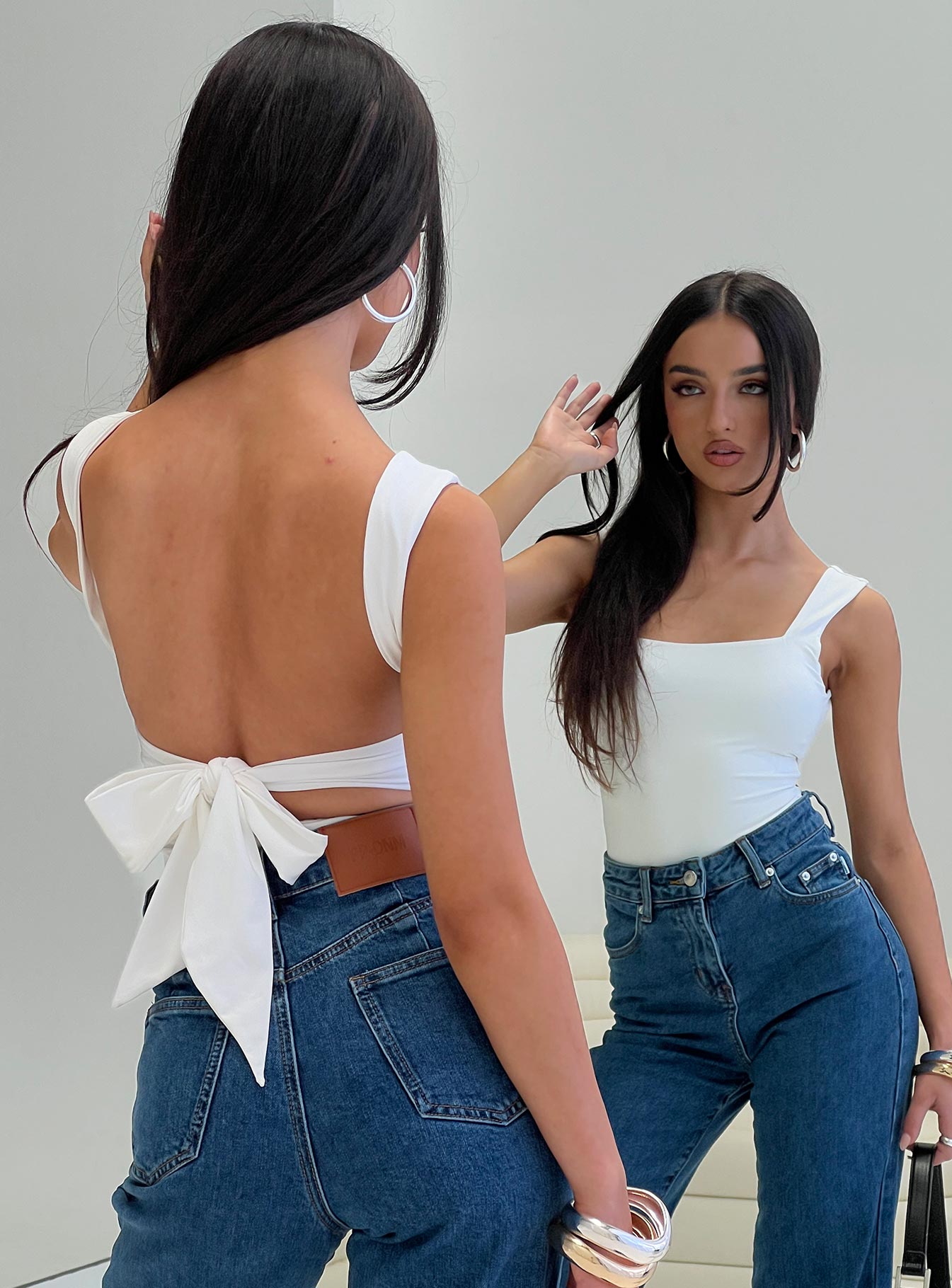 back view of model wearing Princess Polly Karissa Bodysuit White Sleeveless Square Neck 