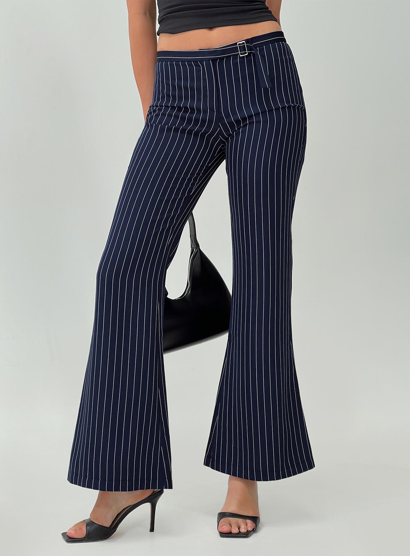 side view of model wearing Princess Polly No One Low Waist Pinstripe Pants Navy Mid Rise 