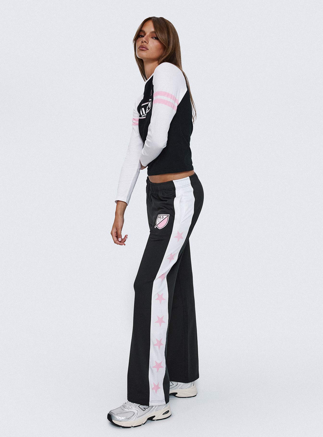 side view of model wearing Princess Polly Track Star Pants Black Low Rise Pants 