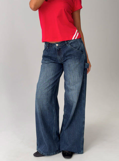 side view of model wearing Princess Polly Downtowner Low Rise Cargo Jeans Mid Blue Wash Low Rise Jeans 