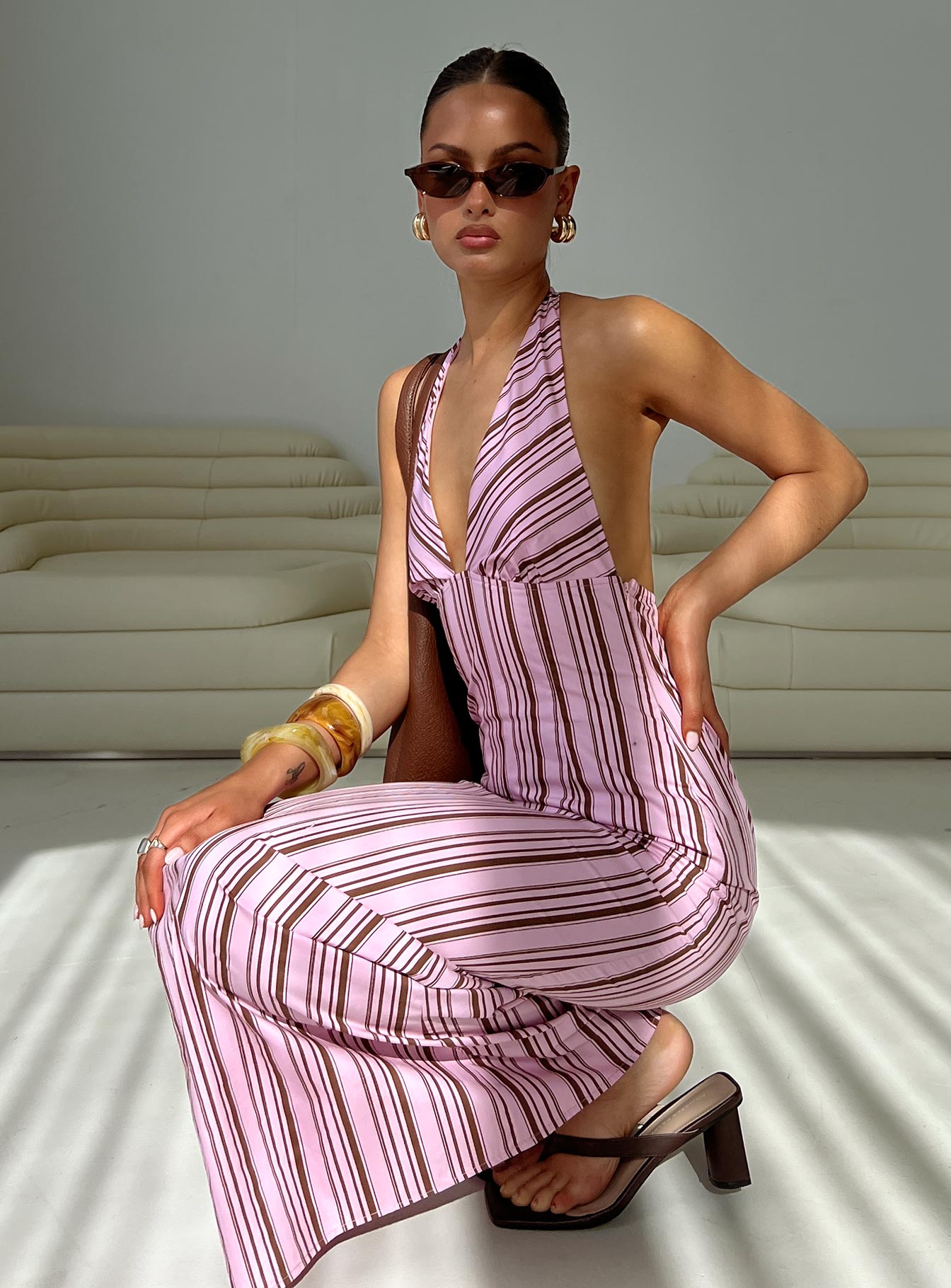 side view of model wearing Princess Polly Avrie Halter Maxi Dress Pink / Brown Stripe Plunger 