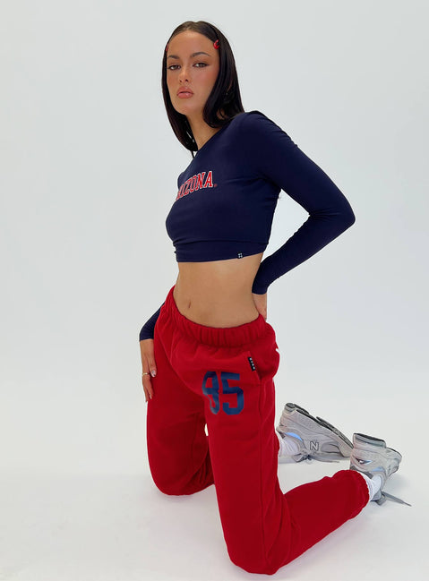 side view of model wearing Princess Polly U of A Sweatpants Red Low Rise Pants 