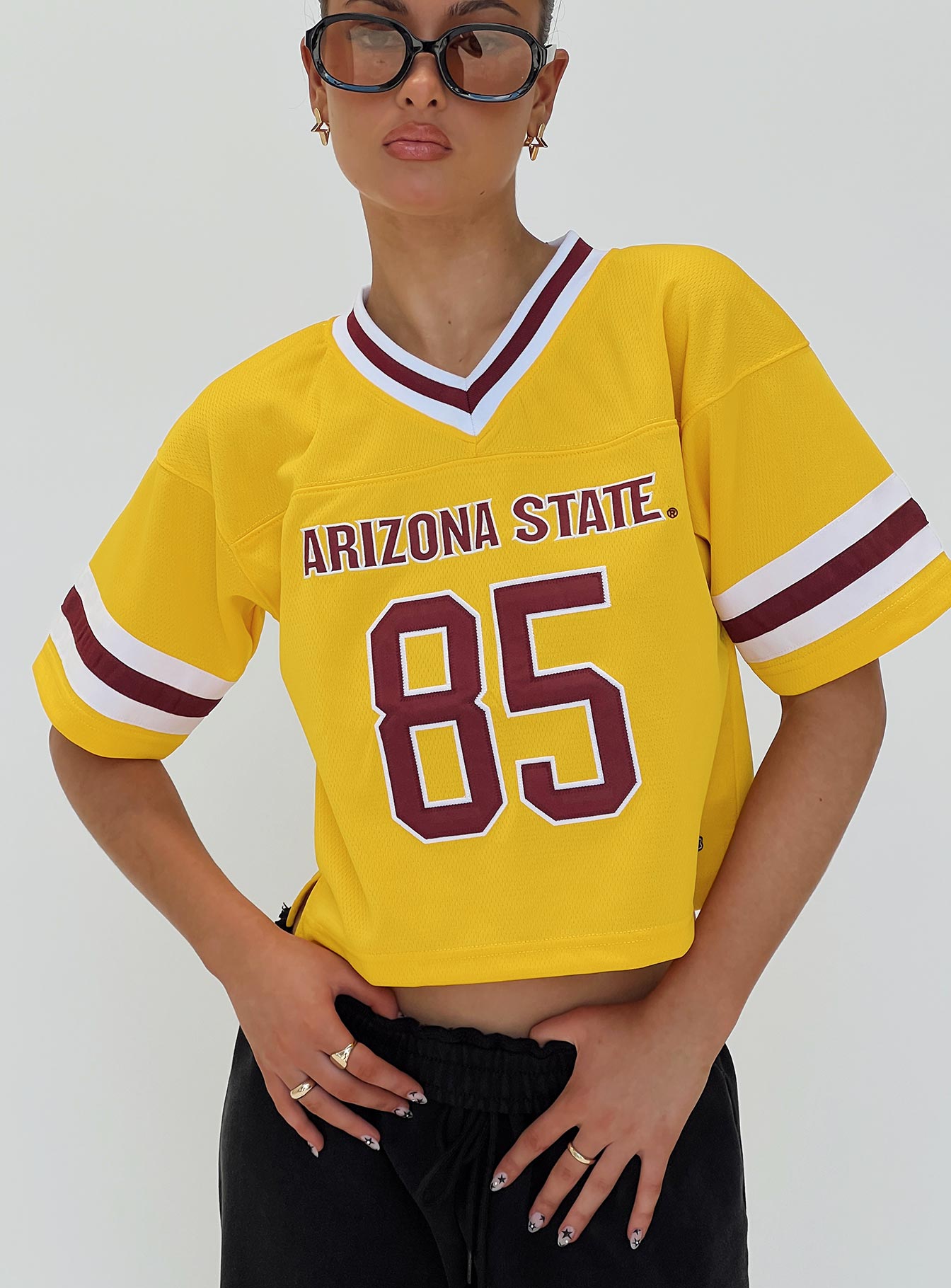 front view of model wearing Princess Polly ASU Football Jersey Gold Half Sleeves V-Neck 