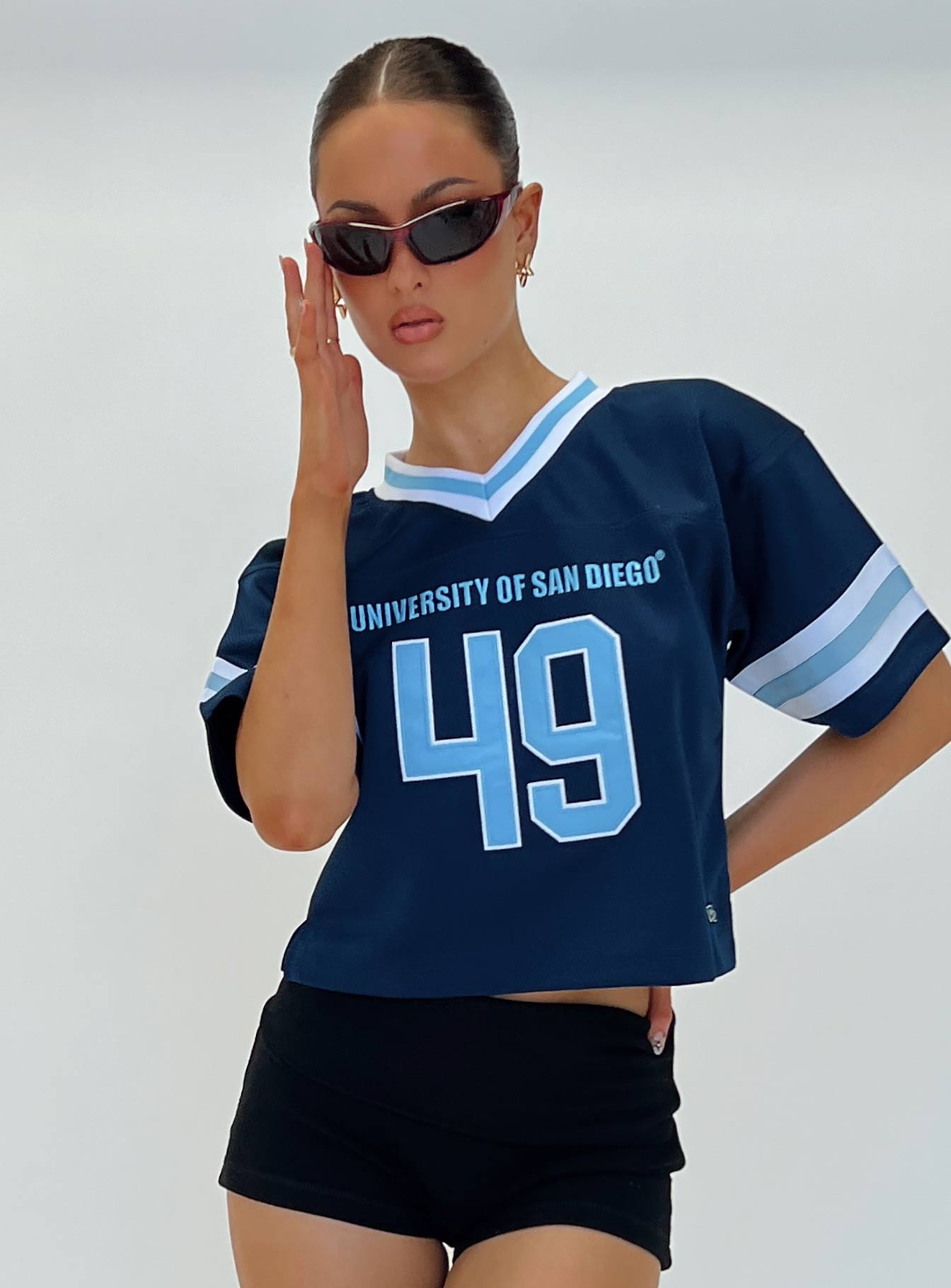 front view of model wearing Princess Polly USD Football Jersey Navy Half Sleeves V-Neck 