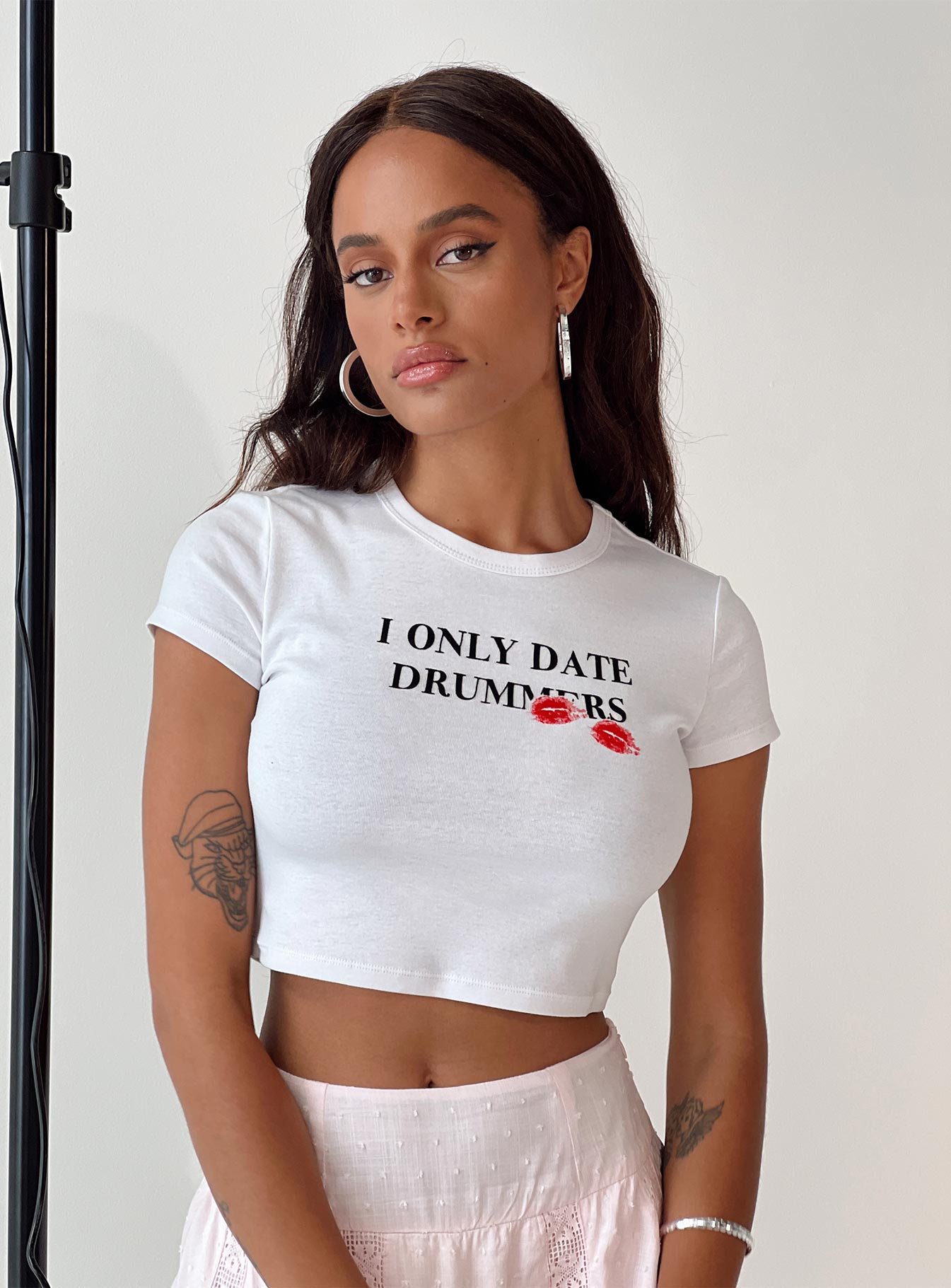 Front view of model wearing  front Princess Polly Short Sleeves Crew Neck  Drummers Baby Tee White