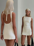 back view of model wearing Princess Polly Mayok Mini Dress Cream Tall High Neck 