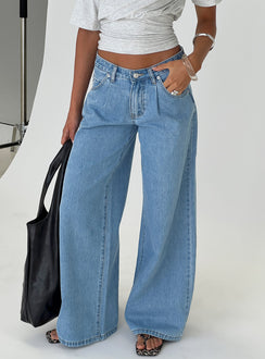 front view of model wearing Princess Polly Supercut Low Rise Baggy Pleat Jeans Light Blue Wash Low Rise Jeans 
