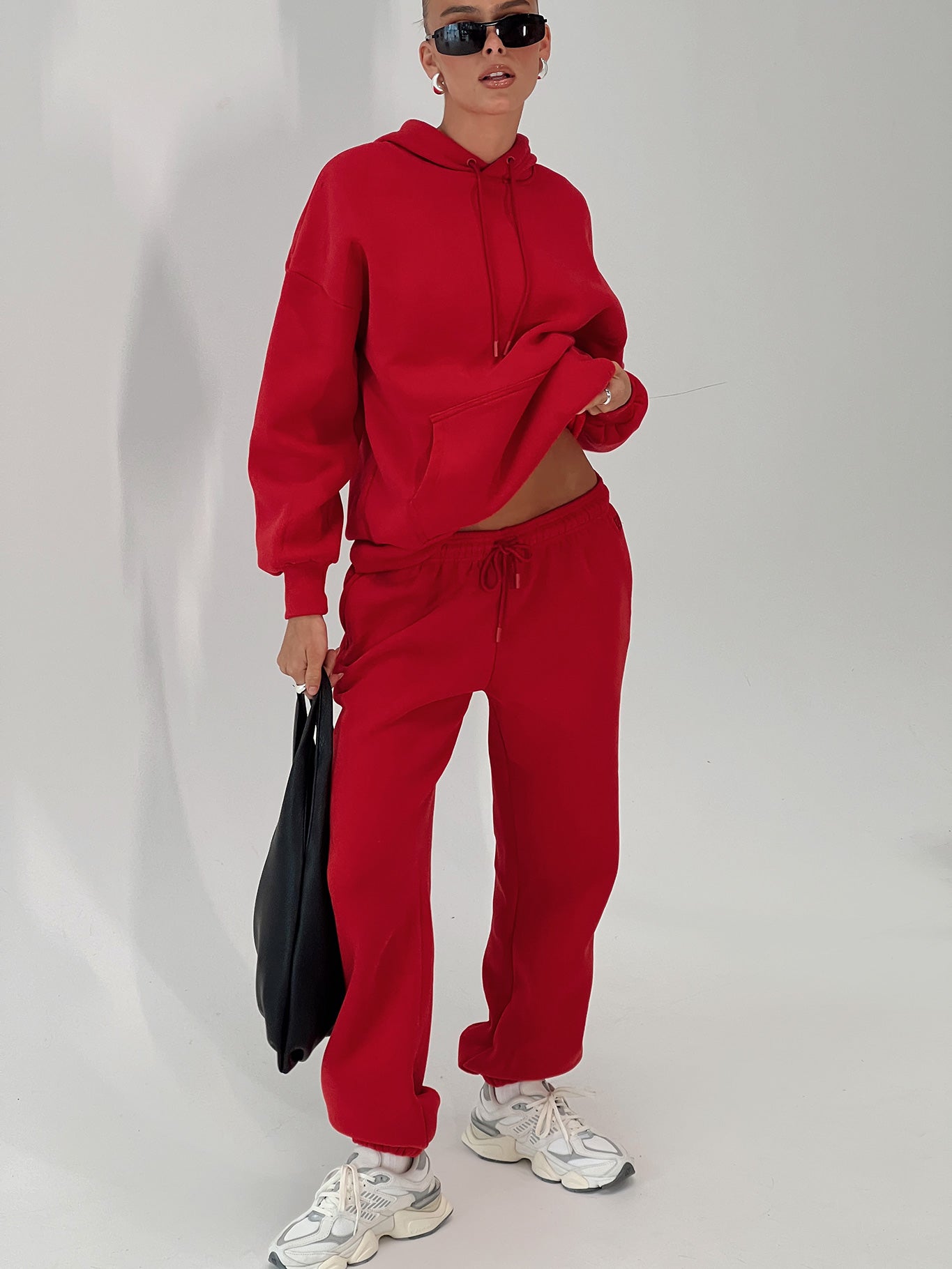side view of model wearing Princess Polly Dream Fleece Ankle Cuff Sweatpants Red High Waisted Pants 