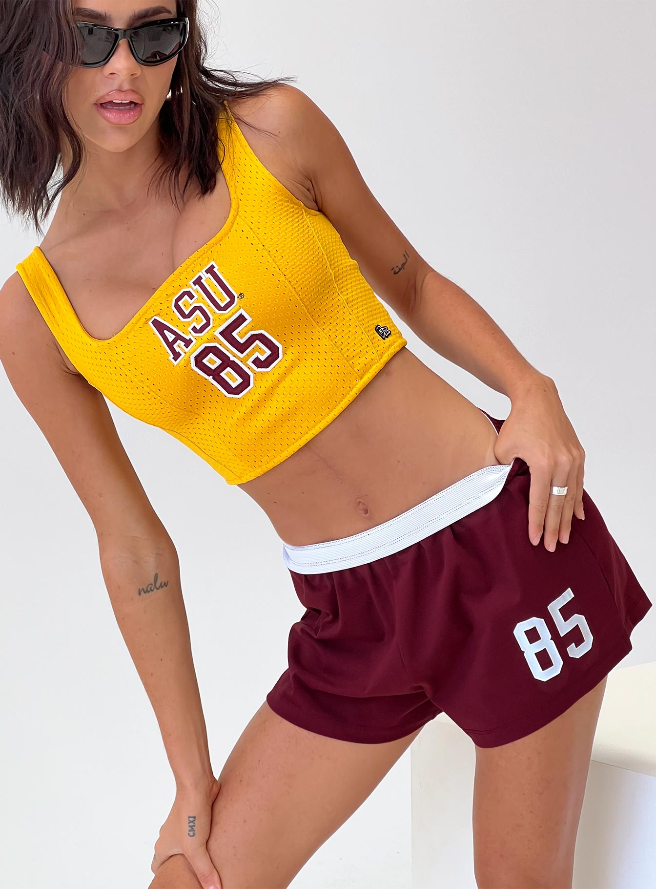 front view of model wearing Princess Polly ASU Soffee Shorts Maroon High Waisted Shorts 