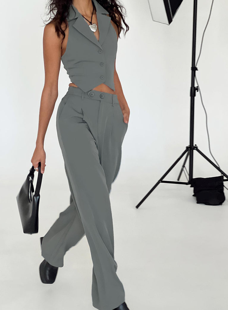 Matching set Vest top  Lapel collar  Button front fastening  High waisted pants  Zip and button fastening  Belt looped waist  Twin hip pockets  Elasticated back Wide leg 