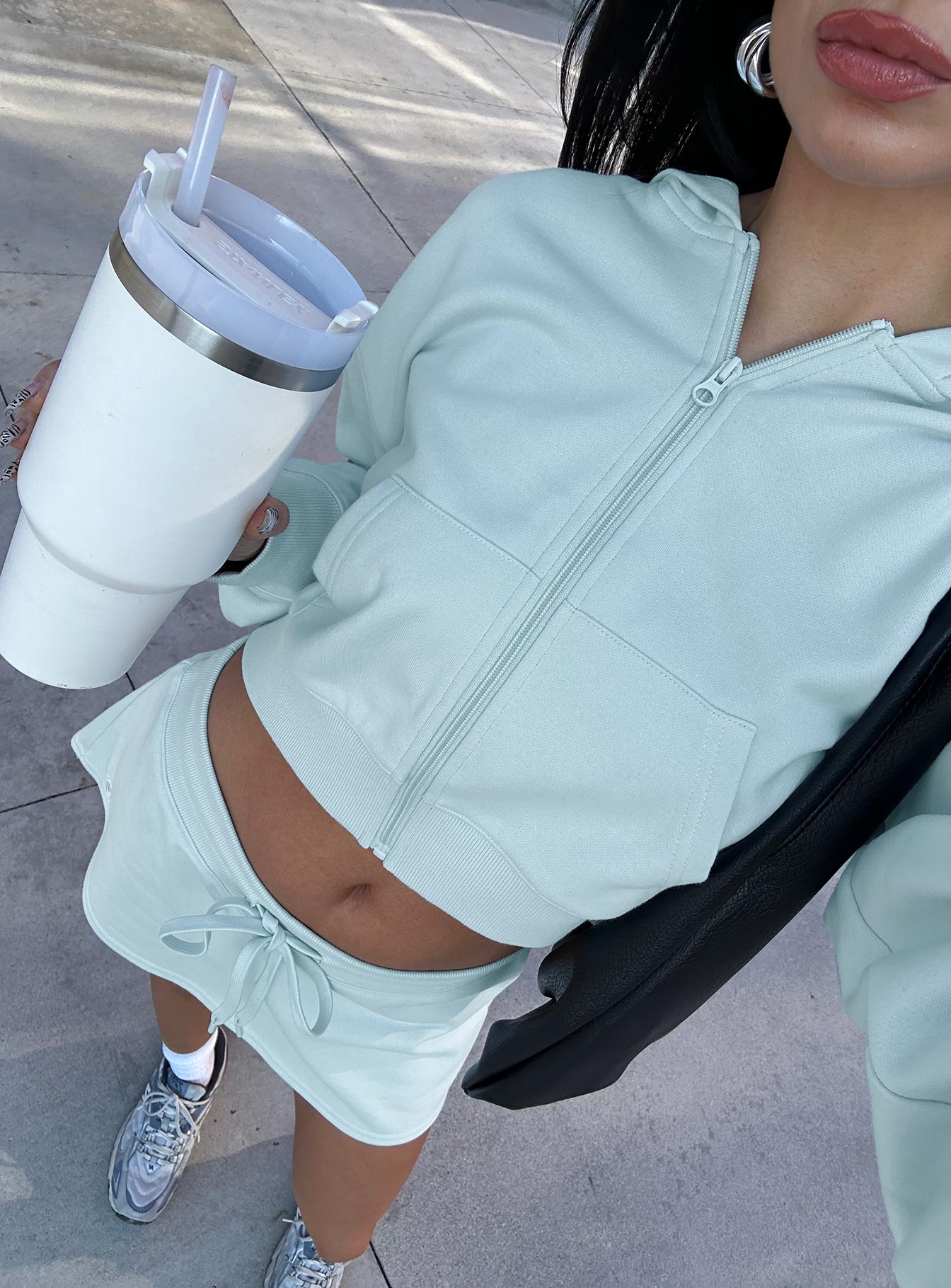 back view of model wearing Princess Polly Revive Zip Through Hoodie Blue cropped 