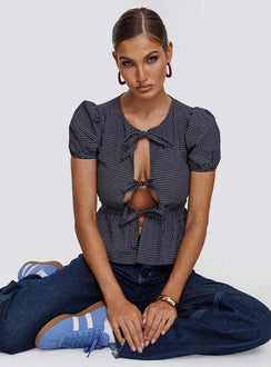 front view of model wearing Princess Polly Verah Tie Up Puff Sleeve Top Navy Check Short Sleeves Scoop Neck 