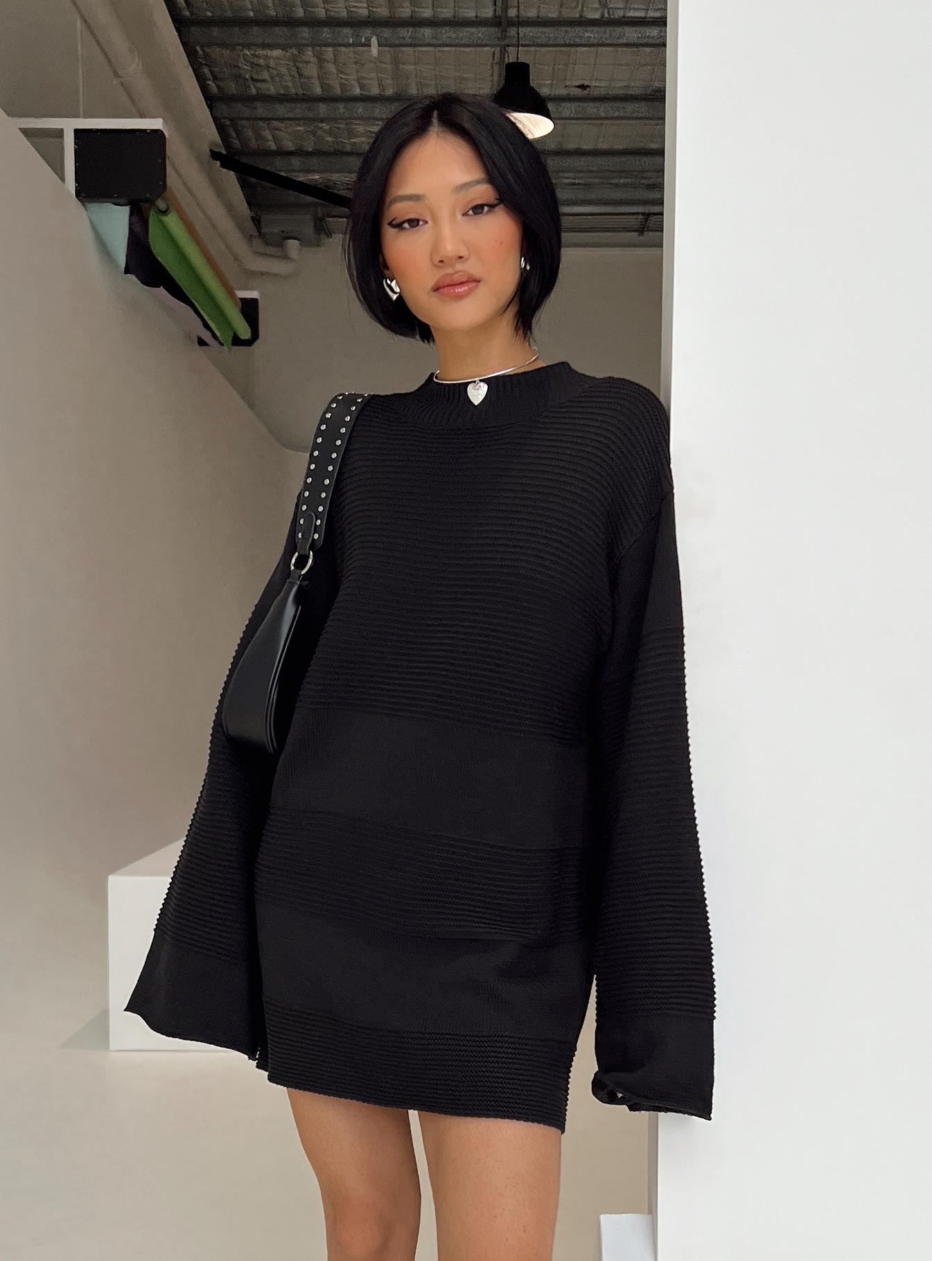side view of model wearing Princess Polly Cheyenne Knit Sweater Dress Black High Neck 