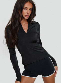 side view of model wearing Princess Polly Celosiah Zip Up Collared Top Black Full Sleeves V-Neck 