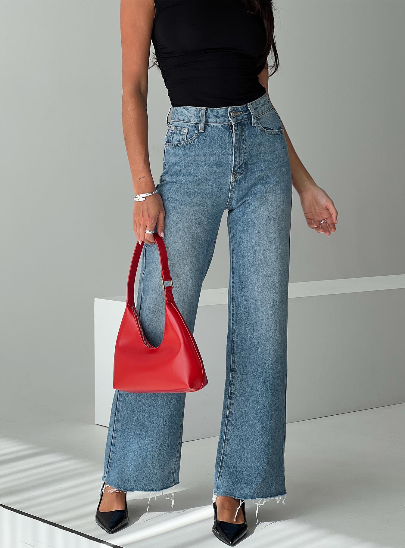 back view of model wearing Princess Polly Henesey Raw Hem Jeans Mid Wash Tall High Waisted 