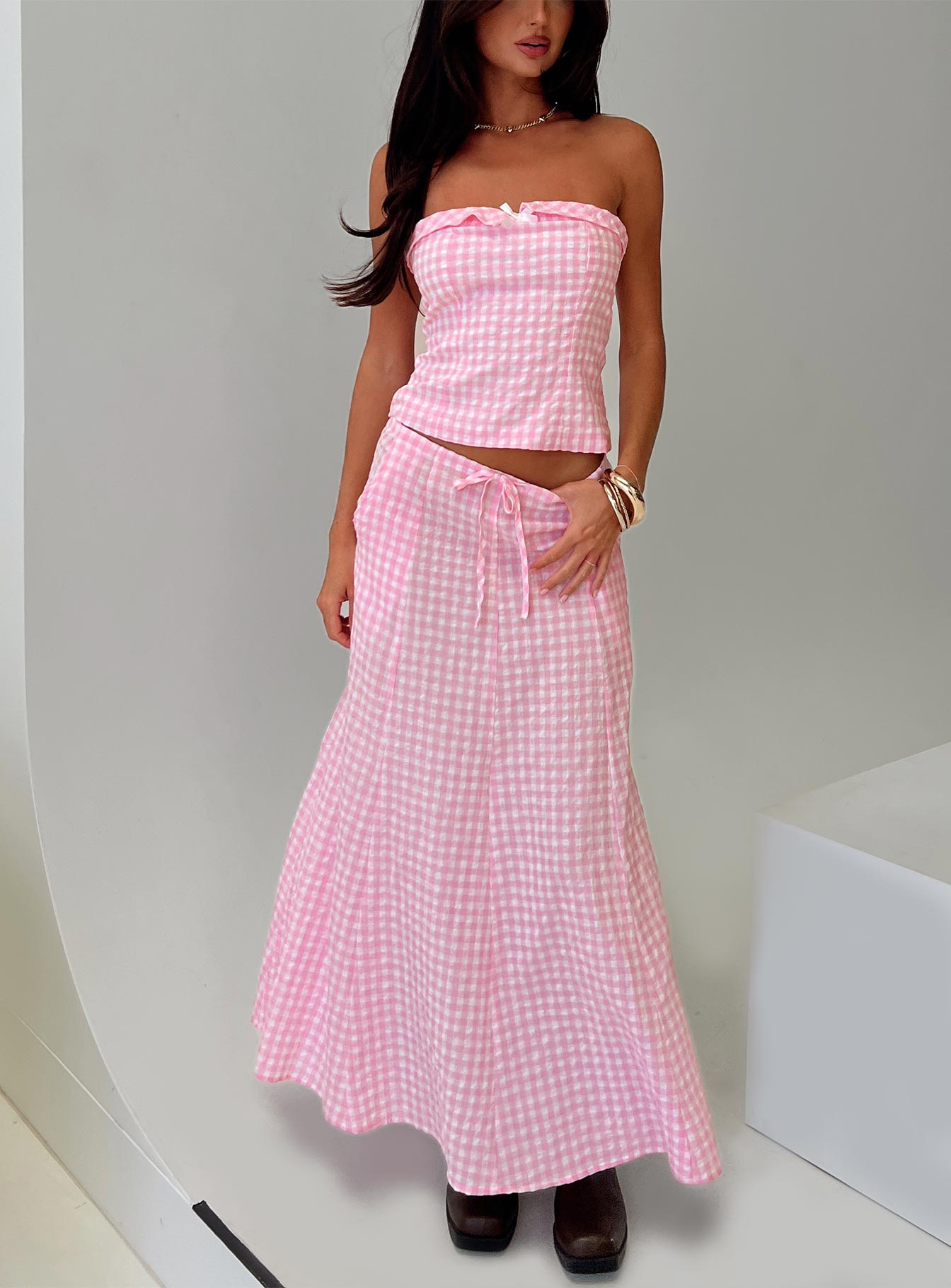   side view of model wearing Princess Polly Carmino Maxi Skirt Pink Check Maxi 