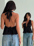 back view of model wearing Princess Polly Saddler Halter Top Black Sleeveless Plunger 