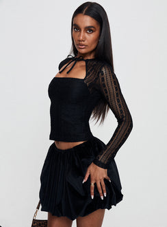   side view of model wearing Princess Polly Georgiana Bubble Hem Mini Skirt Black Mini Skirts 