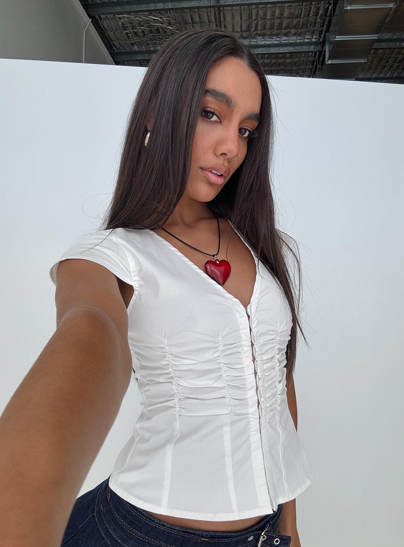 side view of model wearing Princess Polly Indulgence Corset Top White Short Sleeves V-Neck 