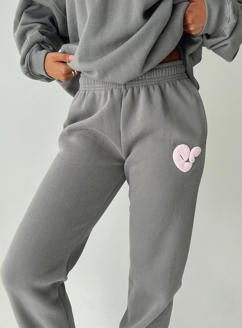 front view of model wearing Princess Polly Princess Polly Track Pants Bubble Text Charcoal / Light Pink Mid Rise 