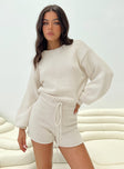 Knit romper  Crew neckline, drop shoulder, balloon sleeves, drawstring fastening at waist, cut out at back with button fastening