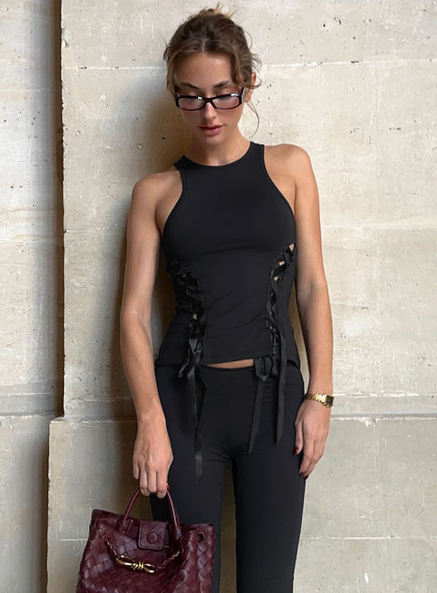 side view of model wearing Princess Polly Bisous Top Black Sleeveless Crew Neck 