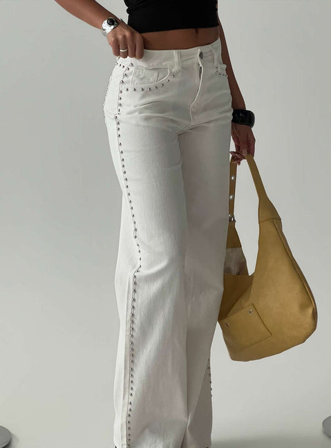 Showcasing the Saving Up Mid Rise Straight Leg Studded Jeans White in womens-jeans with silver studs side view of model wearing Princess Polly