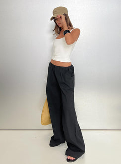 side view of model wearing Princess Polly Lunea Concealed Waistband Pants Black Low Rise Pants 