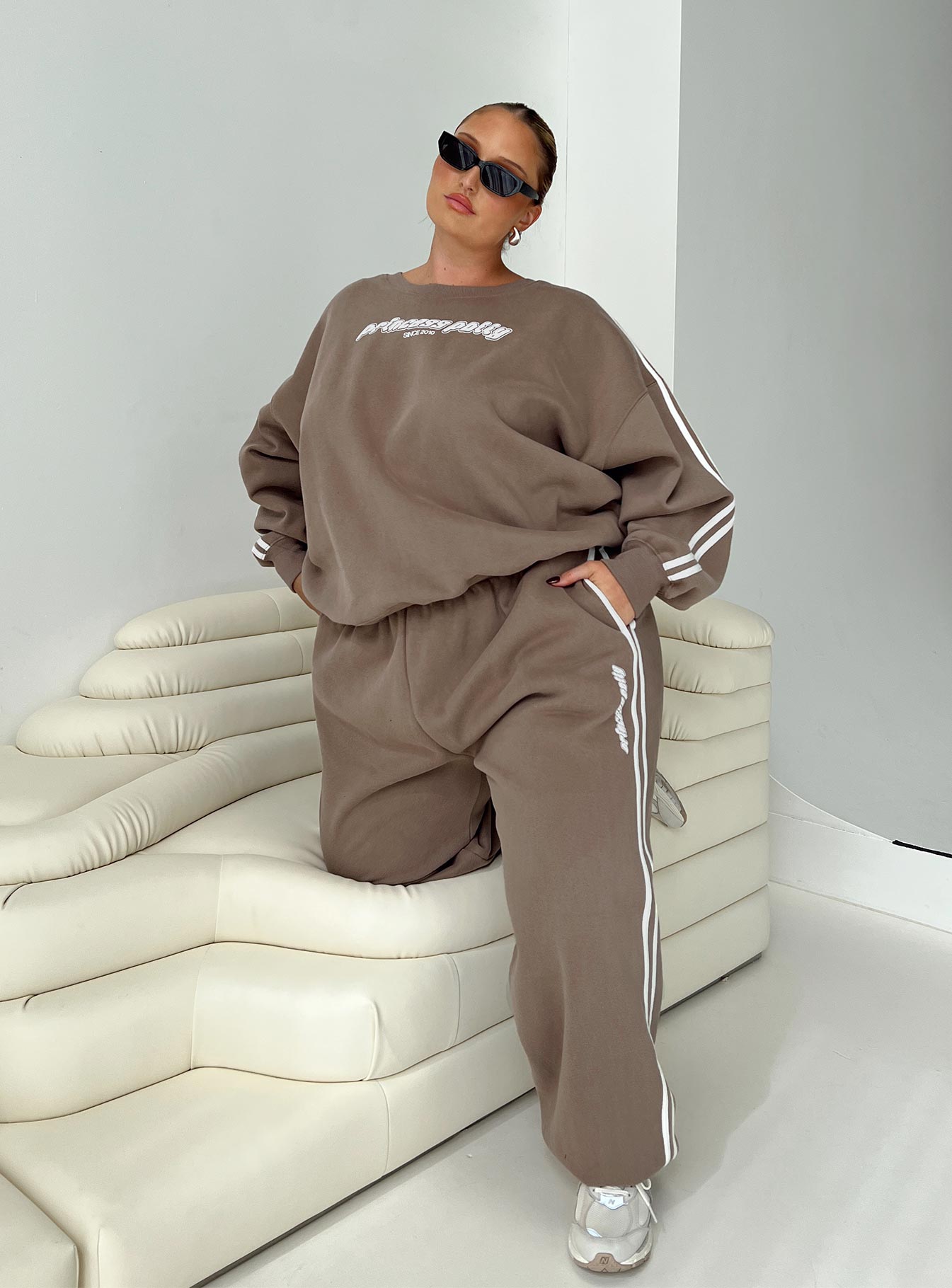 front view of model wearing Princess Polly Princess Polly Track Pants Stripe Taupe / White Curve 