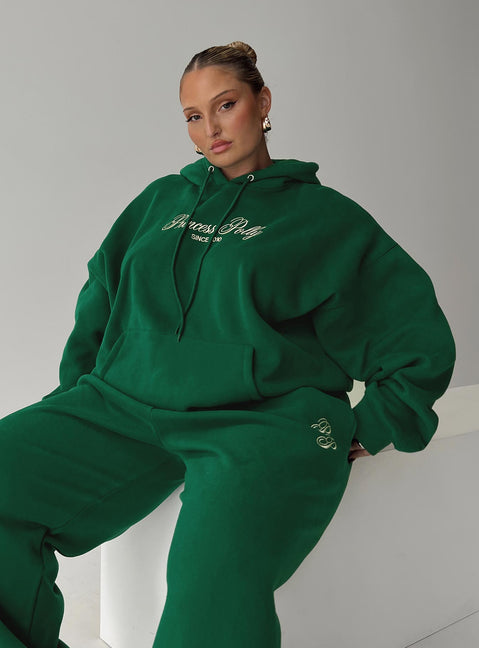 side view of model wearing Princess Polly Princess Polly Hooded Sweatshirt Script Green / Ivory Curve 