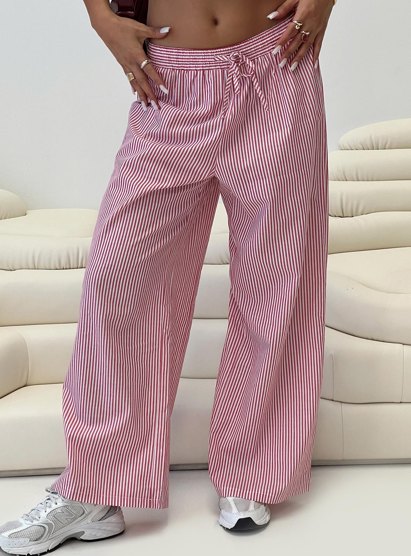 side view of model wearing Princess Polly Holiday Tie Front Pants Red/White Stripe Low Rise Pants 