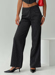 side view of model wearing Princess Polly Kimia Pants Black / White Pinstripe Mid Rise 