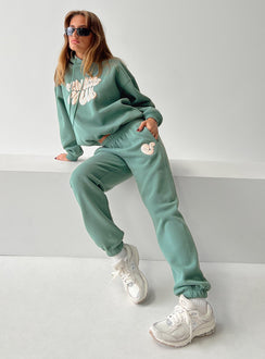 front view of model wearing Princess Polly Princess Polly Track Pants Bubble Text Sage / Eggshell Mid Rise 