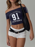 back view of model wearing Princess Polly Serendipia Off The Shoulder Graphic Top Navy Short Sleeves straight 