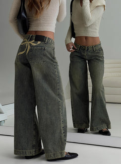 back view of model wearing Princess Polly Ribbon Stamp Wide Leg Jeans Antique Wash Petite Low Rise Jeans 