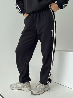 side view of model wearing Princess Polly Princess Polly Track Pants Stripe Black / White High Waisted Pants 