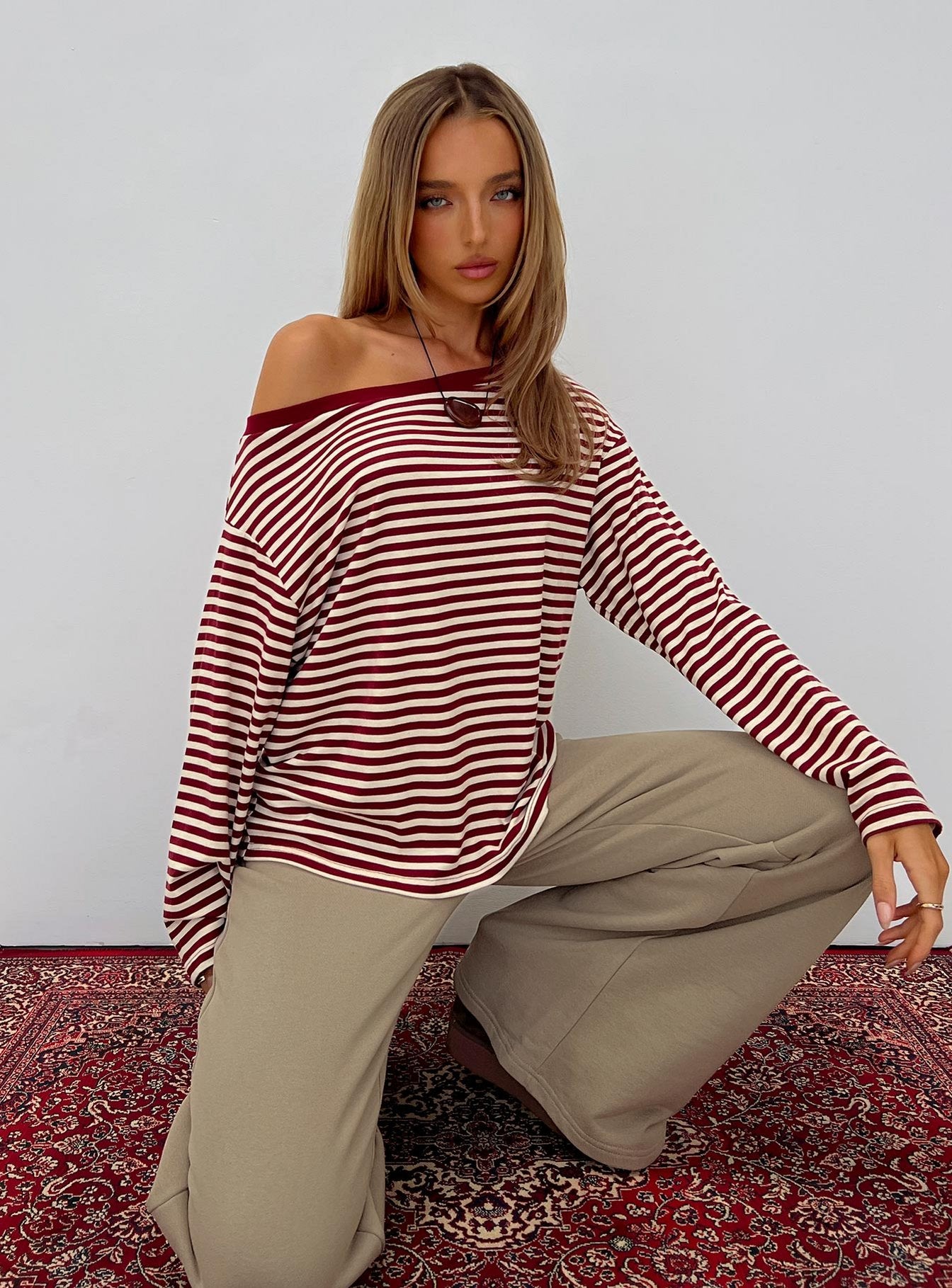 front view of model wearing Princess Polly Ralyssa Off Shoulder Long Sleeve Top Red Stripe Longline Jumpers 