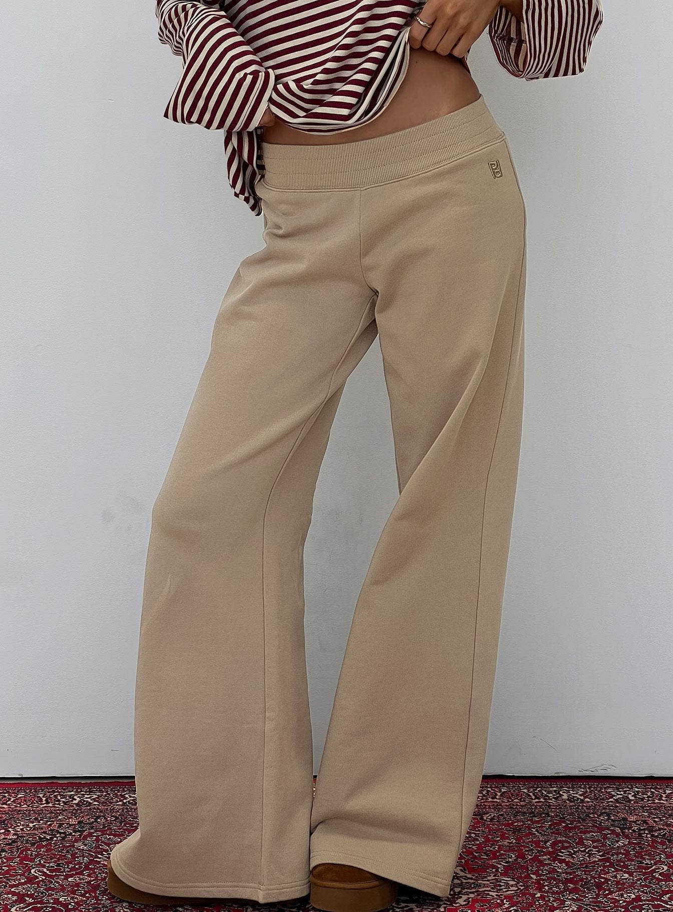 side view of model wearing Princess Polly Summits Flared Track Pants Latte Mid Rise Pants 