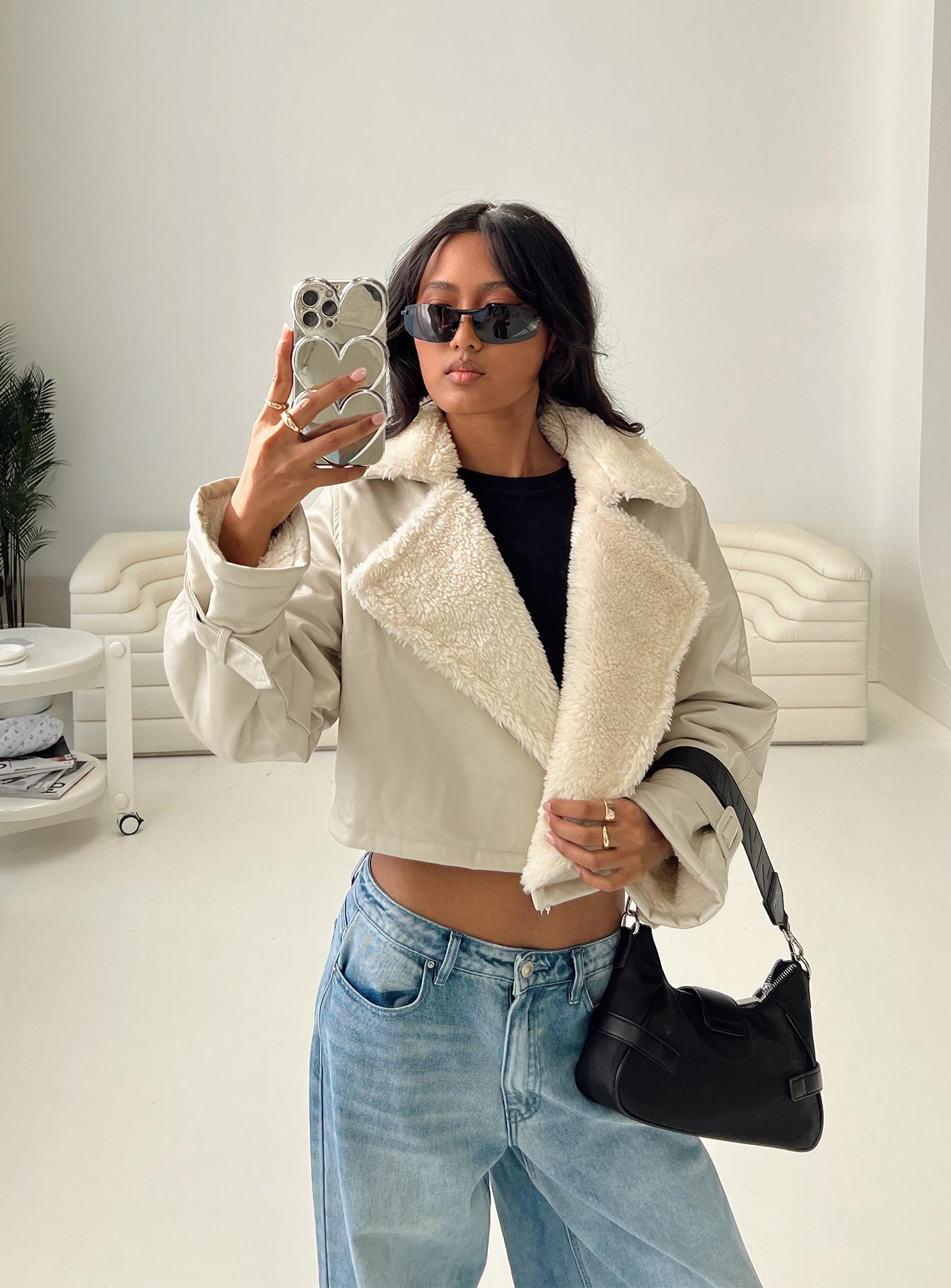 Cropped jacket Faux leather material, oversized collar, removable belts at waist and cuff, buckle fastening