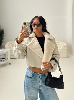 Cropped jacket Faux leather material, oversized collar, removable belts at waist and cuff, buckle fastening